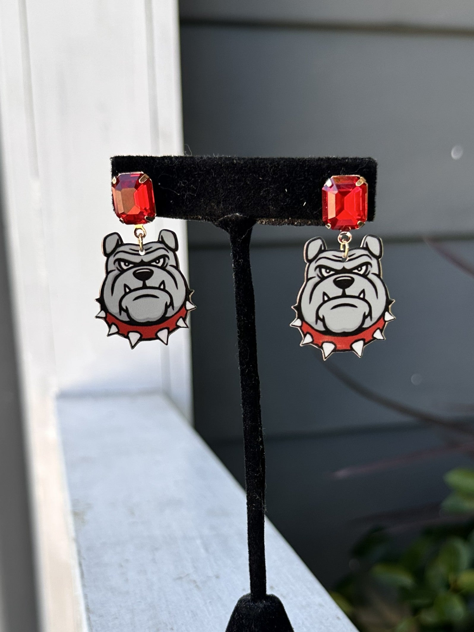 Show your team spirit with these Game Day Bulldog Post Earrings. Featuring a charming bulldog, these earrings are perfect for game day celebrations and showing your pride year-round. The classic post style offers comfortable, everyday wear while making a spirited statement. Whether you're cheering from the stands or showing support around town, these fun earrings bring playful team pride to any outfit.
