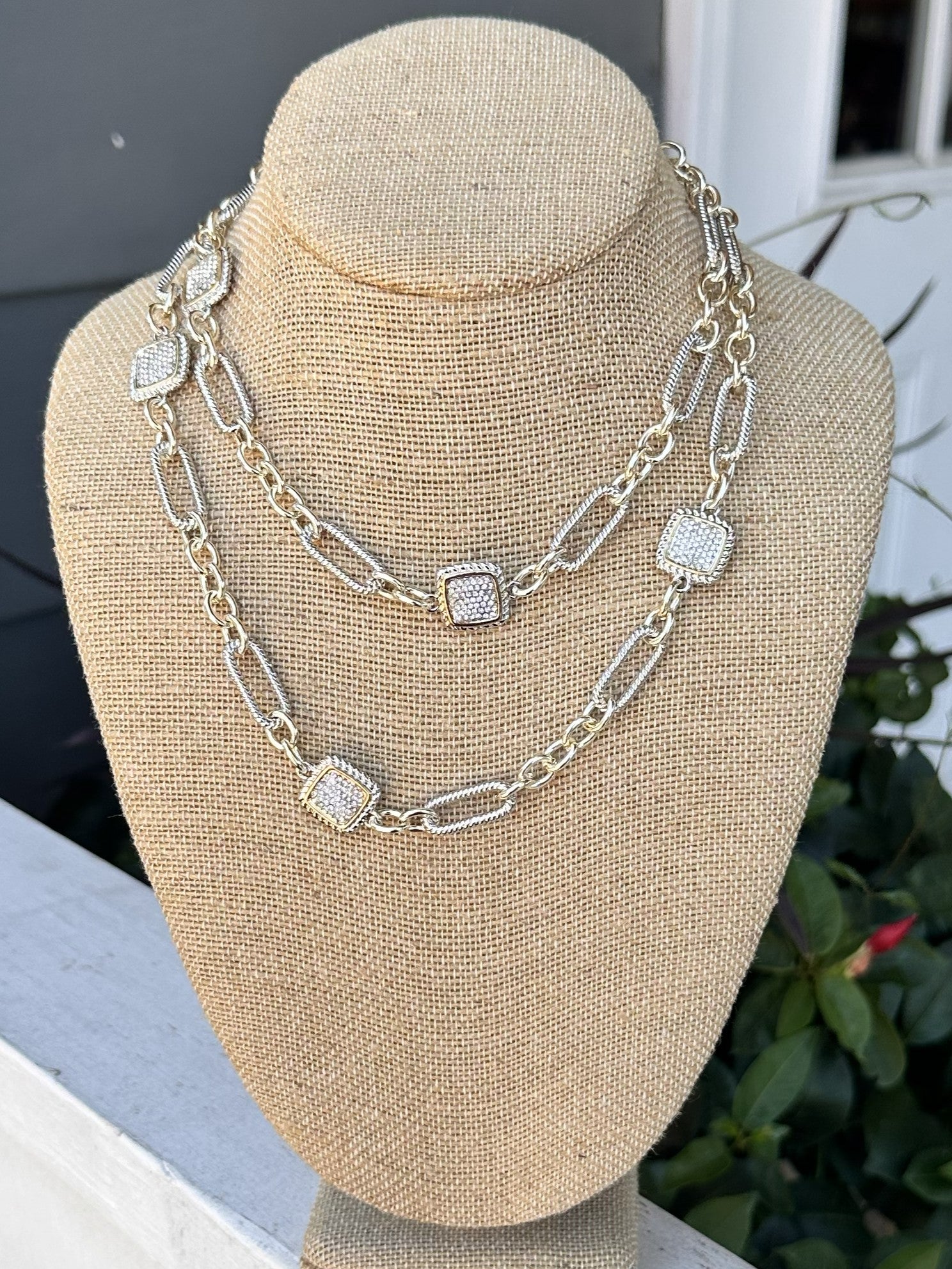 This long silver necklace combines understated sophistication with eye-catching sparkle. Square crystal accents add dimension and light-reflecting beauty to an otherwise minimal design, creating a piece that works with virtually any outfit. Whether worn layered with other pieces or as a standalone statement, it brings refined elegance to your jewelry collection.

Wear it long or short!

Approximate length: 34"
