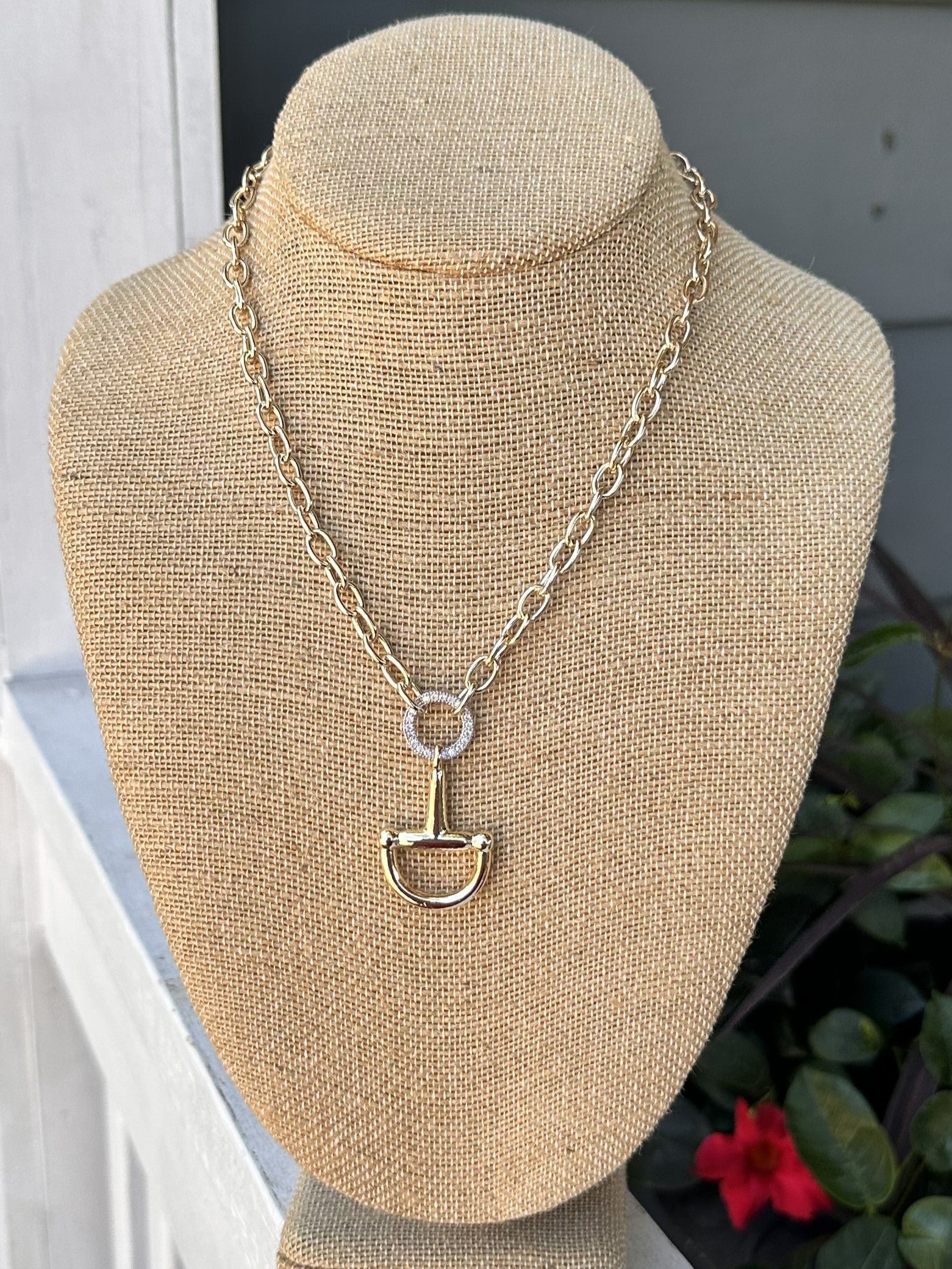 Add a touch of elegance to any outfit with our Gold Snaffle Bit Necklace w/ Rhinestone Accent! The snaffle bit design is so popular and fun. Great for the equestrian enthusiast. Perfect statement piece for any occasion – dressy or casual.

Approximate length: 18-20"