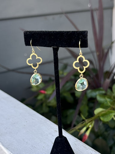 Elegant gold clover earrings featuring a delicate quatrefoil design with luminous green accents. Each drop catches the light beautifully, creating a refined, understated look perfect for everyday wear or special occasions. The combination of warm gold tones and fresh green creates a timeless, sophisticated aesthetic that complements any style.