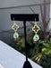 Elegant gold clover earrings featuring a delicate quatrefoil design with luminous green accents. Each drop catches the light beautifully, creating a refined, understated look perfect for everyday wear or special occasions. The combination of warm gold tones and fresh green creates a timeless, sophisticated aesthetic that complements any style.