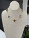 Elegant short necklace featuring cross-shaped pendants in rich tortoise tones, suspended from a gleaming gold chain. Perfect for layering or wearing solo, this versatile piece adds a touch of sophistication to any outfit. The compact length makes it ideal for everyday wear and special occasions alike.

Pair with our matching bracelet.