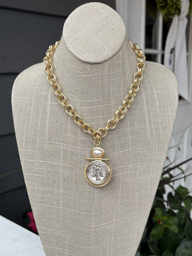 This timeless gold braided necklace combines refined elegance with versatile style. The delicate braided chain showcases expert craftsmanship, while the gleaming coin pendant adds a sophisticated focal point that works beautifully with any look. This necklace transitions seamlessly from day to evening wear. An essential jewelry staple that brings understated luxury to your collection.

Approximate length: 10-20"