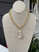 This timeless gold braided necklace combines refined elegance with versatile style. The delicate braided chain showcases expert craftsmanship, while the gleaming coin pendant adds a sophisticated focal point that works beautifully with any look. This necklace transitions seamlessly from day to evening wear. An essential jewelry staple that brings understated luxury to your collection.

Approximate length: 10-20"