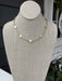 Delicate gold chain adorned with textured gold crosses creates an understated yet sophisticated look. Perfect for layering or wearing alone, this necklace combines minimalist design with timeless elegance. The short length offers versatile styling options for any occasion.
