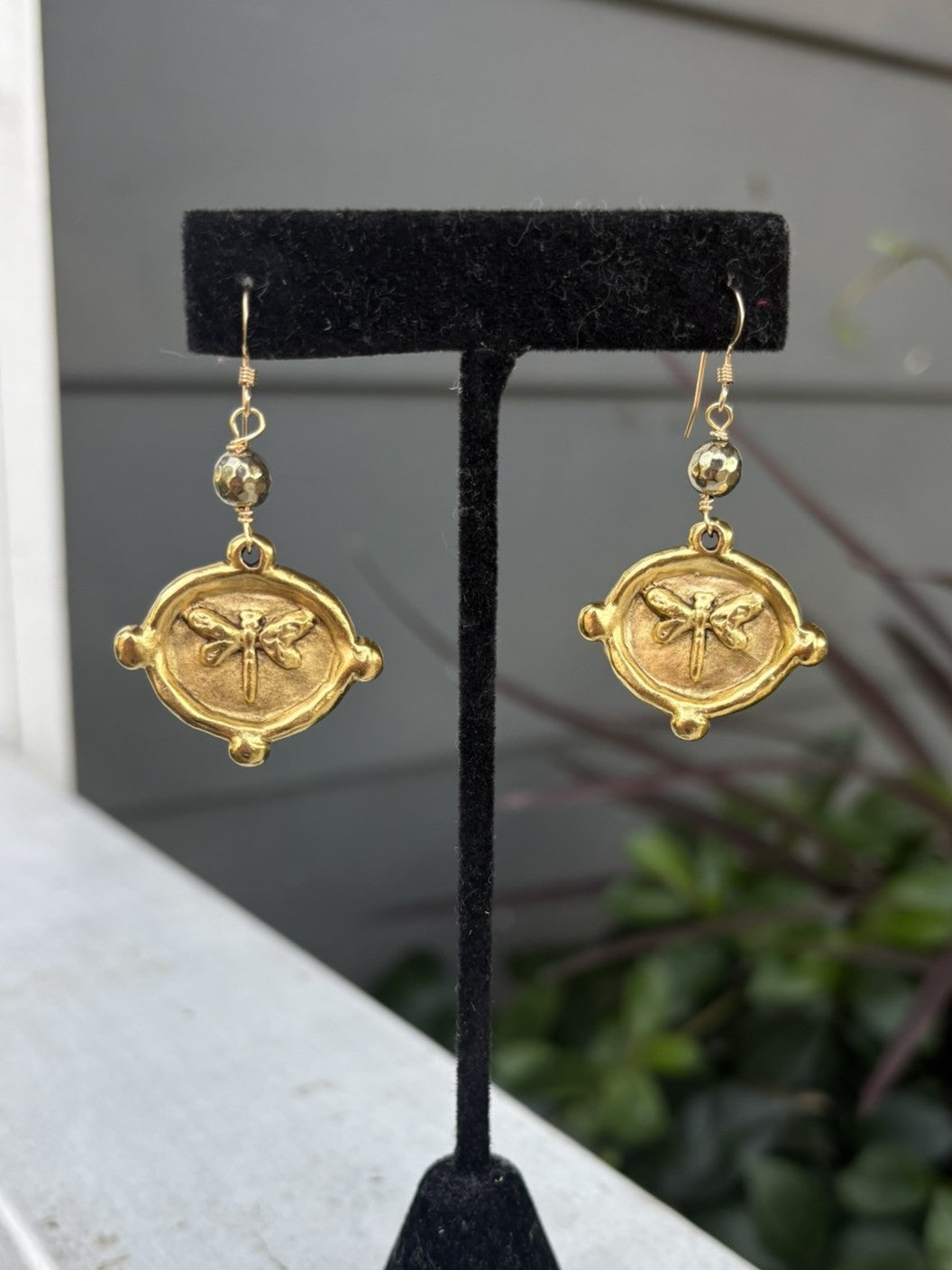 A lovely pair of hammered gold earrings! These earrings featuring a butterfly charm and faceted gold bead are a perfect gift for the garden enthusiast, or butterfly lover.

Designed and made by local artist.