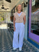 Effortlessly elegant and endlessly wearable, the Solana White Linen Pants bring relaxed sophistication to any wardrobe. Crafted from breathable linen, these pants feature a comfortable elastic waistband with adjustable drawstrings for a customized fit. The flowing wide-leg silhouette flatters every frame, while dual side pockets add practical style. Perfect for warm-weather dressing, from casual weekends to elevated summer occasions.

Material: 55% Linen / 45% Rayon

Care Instructions: Machine Wash Cold