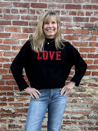 Cozy up in style with our "LOVE" Long Sleeve Sweater! The black background with bold red lettering is so fun, while the crew ribbed neck and cuffs add a touch of elegance. The soft and cozy fabric will keep you warm, and the split ribbed waist adds a modern edge.&nbsp;

Material: 100% Cotton

Care Instructions: Hand wash cold, line dry