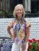 Brighten your summer wardrobe with this cheerful floral top, featuring a striking striped placket that adds visual interest to the front. Short sleeves keep you cool and comfortable, while the vibrant color palette brings playful energy to any outfit. Style it effortlessly with white denim shorts or a white flowing skirt for an instant seasonal look that feels fresh and put-together.

Barbara is wearing a size XSmall.

Material: 100% Cotton

Care Instructions: Hand wash cold, dry flat