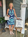 A timeless summer essential with contemporary flair. This sleeveless dress features a striking embroidered design on a soft medium blue canvas, creating visual interest that stands out from everyday pieces. The lined construction ensures comfort and confidence, while the short cut keeps you cool and mobile through warm days. Whether you're heading to brunch, a garden gathering, or a casual evening out, this dress brings together refined craftsmanship and effortless wearability in one versatile silhouette.

