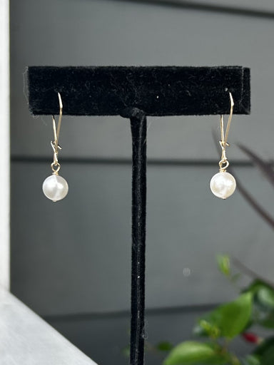 These round pearl earrings are a stunning addition to any outfit. Crafted with gold wired hardware and a dainty design, they are expertly crafted to be both stylish and elegant. The beautiful pearl drops create timeless looks that will have you looking your best.