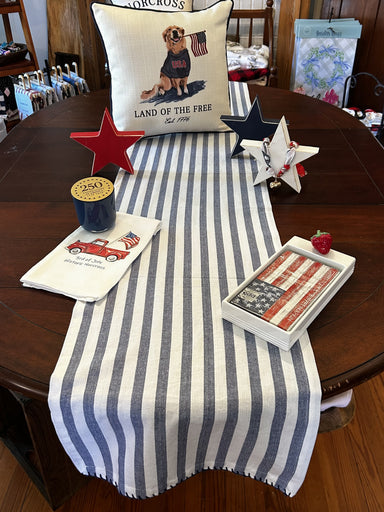 Crisp blue and white stripes bring timeless appeal to any space. This lightweight runner works beautifully for patriotic displays, spring gatherings, and summer entertaining. The whipstitched edges add refined detail and durability. Perfect for entryways, kitchens, or seasonal décor that celebrates classic American style.

Dimensions: 16 x 72 Oblong

Material: 100% Cotton

Care Instructions: Cold Hand Wash, Hang Dry, Medium Iron