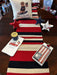 Celebrate your patriotic spirit with this charming Stripe Americana Runner. Featuring a classic red, white, and natural color palette, this versatile piece brings timeless holiday charm to any space. The decorative fringe ends add a rustic, handcrafted touch perfect for Independence Day, Memorial Day, and other patriotic occasions. An ideal accent for entryways, tables, or shelves during seasonal celebrations.

Dimensions: 16 x 72 Oblong

Material: 100% Cotton

Care Instructions: Spot clean