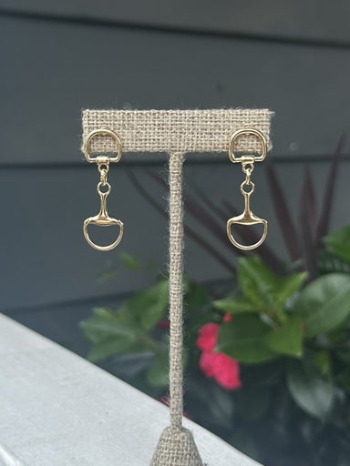 These timeless snaffle bit post earrings bring equestrian elegance to your jewelry collection. Rendered in lustrous gold, each earring features the recognizable horse bit motif in a graceful drop style. The post setting provides secure, comfortable wear throughout the day. A sophisticated choice for horse lovers and anyone who appreciates classic, refined accessories with character.