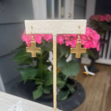 These lovely cross earrings are handmade in Atlanta. They are simple and make a statement, in a hammered matte gold finish.&nbsp;
