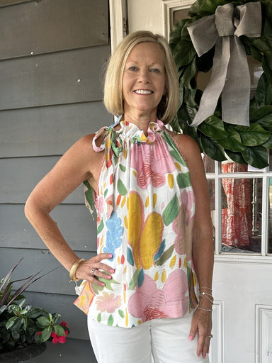 Discover effortless elegance with this colorful sleeveless top, perfect for sun-soaked adventures and casual gatherings. Featuring a striking abstract print framed by delicate lace trim, the adjustable tie neck creates a personalized fit for any body type. The lightweight rayon-nylon fabric keeps you cool and comfortable throughout the day. Ideal for beach trips, and summer outings.&nbsp;

Material: 85% Rayon / 15% Nylon

Care Instructions: Hand wash cold, hang to dry