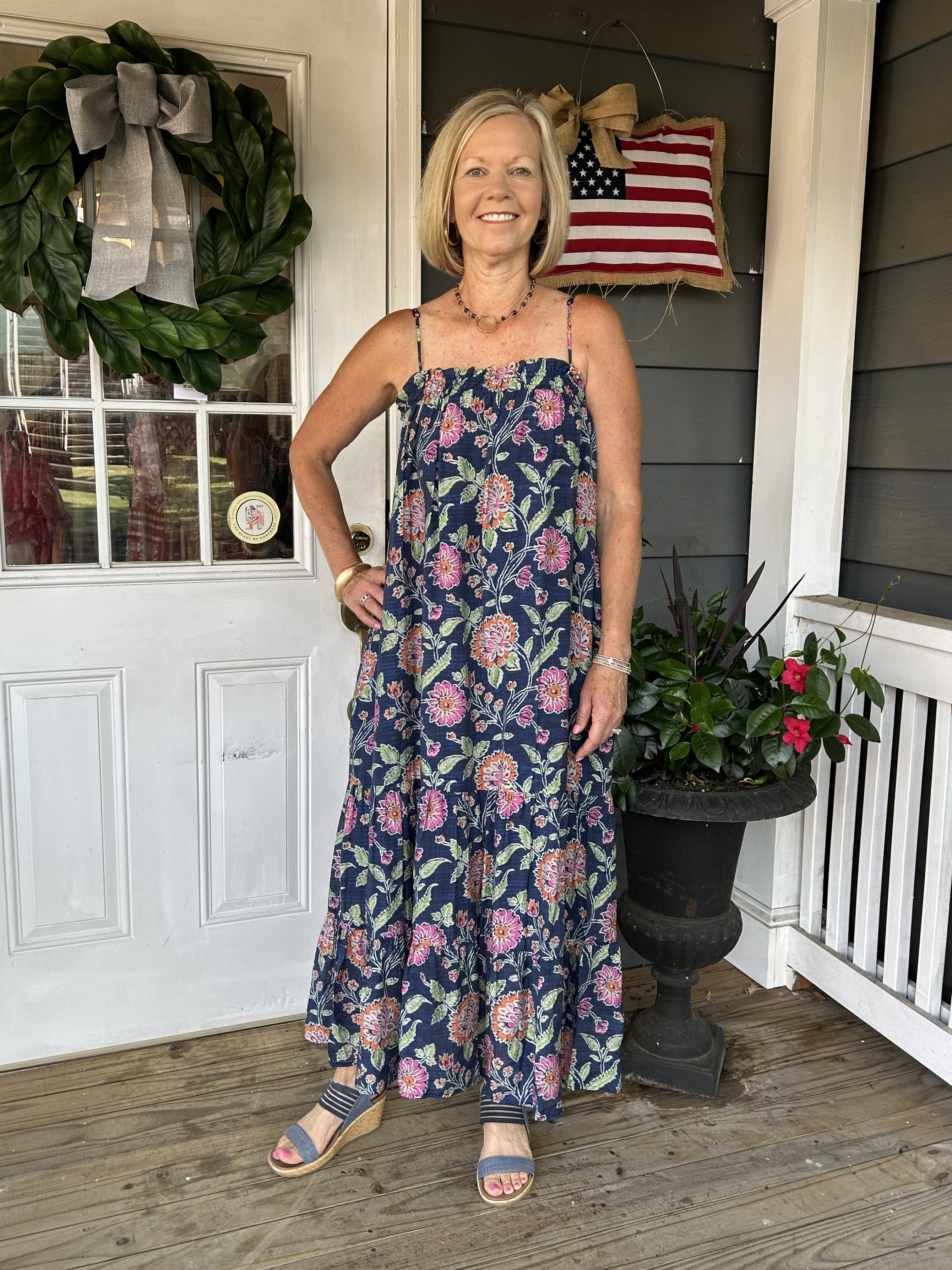Escape to effortless summer style with this enchanting spaghetti strap maxi dress. Delicate florals dance across a sophisticated navy background, creating a look that's both romantic and refined. The gracefully tiered skirt adds movement and dimension, while hidden side pockets and a lined skirt offer practical elegance. Perfect for beach days, garden parties, or any occasion calling for breezy sophistication. Slip it on and feel the difference quality craftsmanship makes.

Material: 80% Rayon / 20% Nylon

