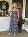 Escape to effortless summer style with this enchanting spaghetti strap maxi dress. Delicate florals dance across a sophisticated navy background, creating a look that's both romantic and refined. The gracefully tiered skirt adds movement and dimension, while hidden side pockets and a lined skirt offer practical elegance. Perfect for beach days, garden parties, or any occasion calling for breezy sophistication. Slip it on and feel the difference quality craftsmanship makes.

Material: 80% Rayon / 20% Nylon

