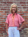 A vibrant blend of pink and orange creates an eye-catching color story on this versatile summer essential. The ruched collar adds textural interest and a polished touch, while the contrasting front pocket brings playful detail. Style it tucked or untucked for effortless day-to-night versatility. Perfect for warm-weather dressing with an instant pop of color.

Barbara is wearing a size XSmall.

Material: 85% Rayon / 15% Linen

Care Instructions: Gentle cool hand wash cold, dry flat