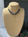 Elegant bead and chain necklace featuring rich lapis beads paired with delicate open gold chain. The centerpiece showcases a long, hammered cross pendant with beautiful texture and dimension. A sophisticated piece that combines natural stone beauty with refined metalwork for a timeless look.

Approximate length: 19-21"