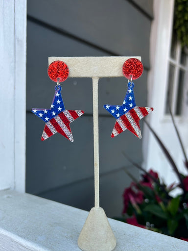 Patriotic star-shaped earrings celebrating American pride. Crafted from lightweight acrylic with secure post backs for all-day comfort. Perfect for Independence Day, patriotic events, or everyday wear for flag enthusiasts. These eye-catching stars bring a bold pop of red, white, and blue to any outfit.