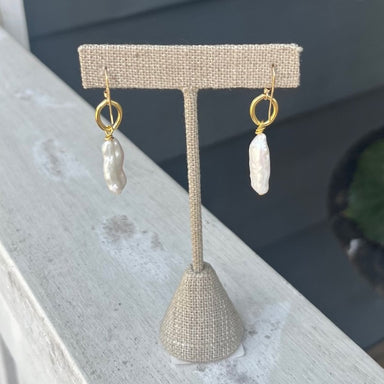 These elongated pearl earrings are a stunning addition to any outfit. Crafted with gold wired hardware and a dainty design, they are expertly crafted to be both stylish and elegant. The beautiful pearl drops create timeless looks that will have you looking your best.