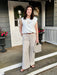 Timeless striped elegance in a modern silhouette. The Maia Striped Cotton Pants feature a sophisticated ivory and oak stripe that transitions seamlessly from casual to refined. The generous wide-leg cut and breathable cotton fabric make them ideal for warm weather, while belt loops add polished detail. Style them with crisp ivories, or warm beiges/browns for endless outfit possibilities.

Material: 100% Cottom

Care Instructions: Machine Wash Cold