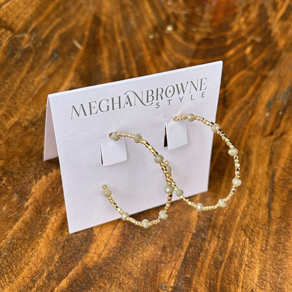 Elegant post hoop earrings featuring delicate gold beads complemented by sophisticated gray faceted accents. The lightweight design ensures all-day comfort, while the timeless hoop silhouette adds versatile style to any look. Perfect for everyday wear or special occasions.