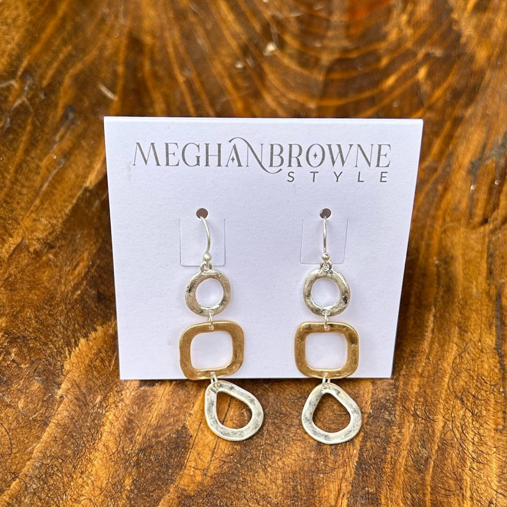 Discover the perfect balance of style and versatility with these Mixed Metal Hammered Dangle Earrings. Crafted with a beautiful blend of gold and silver, the hand-hammered texture creates depth and character that catches light from every angle. The gentle dangle movement adds grace and fluidity to your look, whether you're dressing up for a special occasion or keeping it casual. These earrings seamlessly transition between any outfit, making them an indispensable addition to your jewelry collection for thos