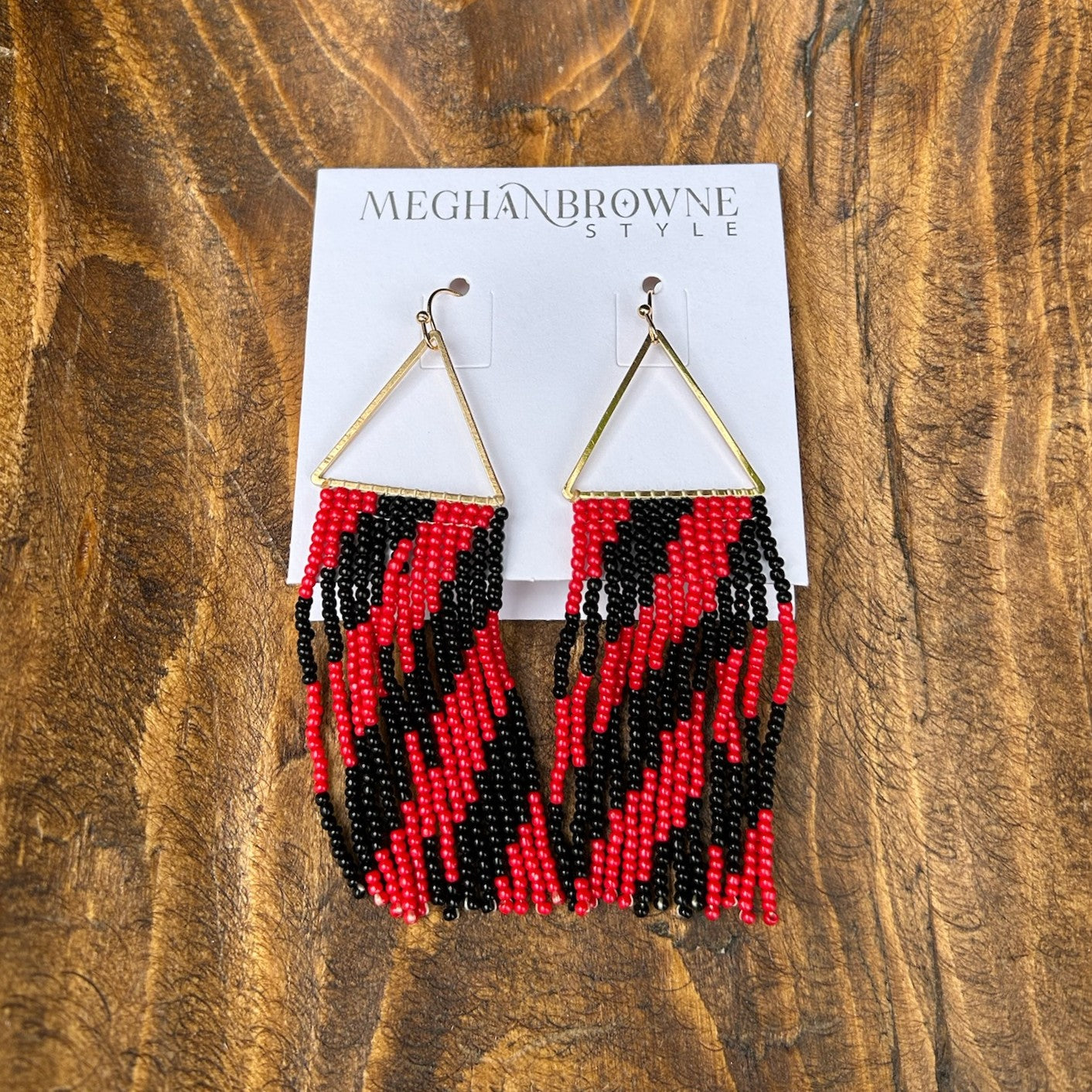 These Red &amp; Black Beaded Dangle Earrings are your go-to accessory. Crafted with precision beadwork, the bold red and black palette brings instant sophistication to game day looks, casual outings, or dressed-up evenings. Lightweight yet impactful, they deliver all the style without sacrificing comfort. Perfect for anyone seeking jewelry that balances statement-making design with practical, all-day wearability.