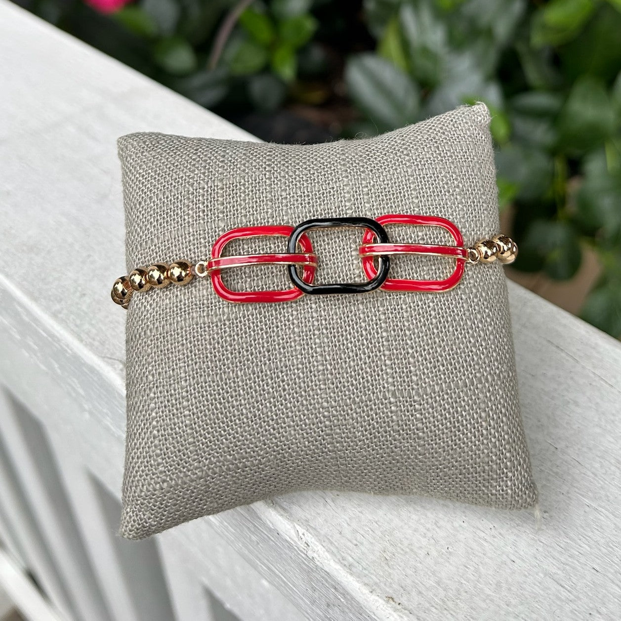 Show your team pride with this eye-catching stretch bracelet. Crafted with gleaming gold beads and accented by vibrant red and black oval links, it's the ultimate game day accessory that transitions seamlessly from the stadium to everyday wear. Comfortable, stylish, and designed to make a statement.