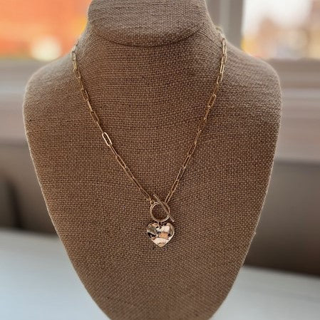 Look stylish in this gorgeous Short Necklace with Heart Pendant. Its beautifully crafted solid heart pendant and T-bar clasp combine for a contemporary take on classic elegance. Add the perfect finishing touch to your outfit!  Approximate length: 19"