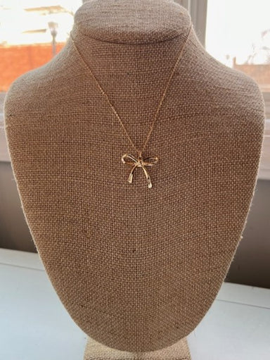 This stunning gold necklace features an adjustable length and a precious bow pendant. The dainty design adds a touch of elegance to any outfit.  Approximate length: 17-20"