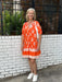 Even those of us who don't wear orange are drawn to this cute dress with it's slightly puffed sleeves and sweet print! It's the perfect length, hitting just above the knee, is lined, and has a sweet floral print in white with a double ring border around the skirt. The cute blue and white striped placard adds that THML touch of something unexpected and fun. It has a flirty fit that's true to size.

Barbara is wearing a small.&nbsp;

Material: 65% Cotton / 35% Nylon

Care Instructions: Gentle cool hand wash, 