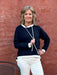 This Navy Hoodie with white trim just says boating, beach, spring,... Pair it with your fav white denim or shorts and little sneaks and you'll just feel happy.&nbsp; It's made of a light weight sweater fabric that breaths and is so soft.&nbsp;

Tricia is wearing a small and has on a pair of our white Risen cropped jeans.&nbsp;

Material: 60% Polyester / 40% Rayon

Care Instructions: Hand wash cold water, dry flat