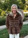 Luxurious faux fur hooded zip-up coat in a gorgeous deep brown. Features a playful oversized hoodie and faux leather tie belt that cinches at the front or back for versatile styling. The perfect layer for transitional weather—dress it up over a skirt or wear it casual with jeans. Premium craftsmanship meets effortless wearability.