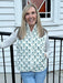 A cozy quilted vest that layers beautifully with everything in your closet. Features a charming floral print, snap-up front closure, and practical side pockets. Wear it over your favorite tee, pair with jeans or a flowy skirt, or layer under a jacket for extra warmth.