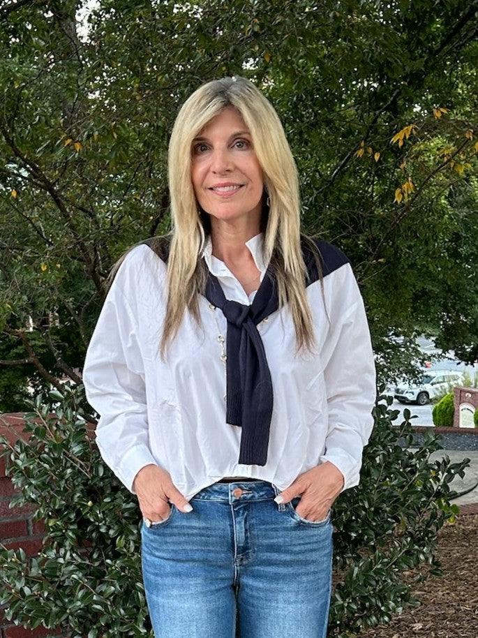 Fun layering meets timeless style with this classic white button-down shirt paired with a lightweight navy knit shawl. The shawl ties elegantly around the neck, offering versatile coverage and warmth without bulk. Perfect for transitioning between seasons or dressing up any casual outfit, this combination delivers comfort and sophistication in one coordinated set.