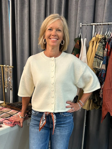 A versatile button-down sweater crafted from lightweight fabric, perfect for layering and transitioning between seasons. Available in two sophisticated color options—cream and pink—each designed to complement a range of styling choices. Pair with your favorite scarf or necklace to elevate any look. The relaxed fit and refined construction make this piece a wardrobe essential for effortless sophistication.