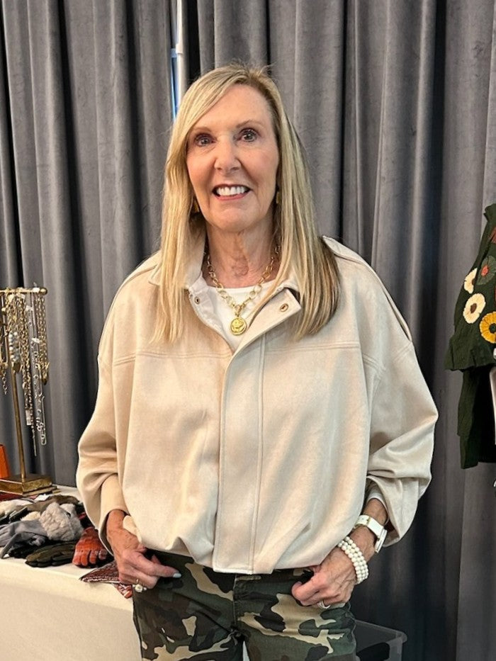 Crafted from sumptuous suede, this zip-up jacket combines timeless elegance with modern comfort. The warm beige hue works seamlessly with any outfit, while the front zip and subtle placket offer practical style. A pleated hem creates visual interest and movement, complemented by thoughtfully placed stitching and distinctive shoulder details. The soft, luxurious feel makes it ideal for layering or wearing as a statement piece. A versatile essential that transitions effortlessly from day to night.