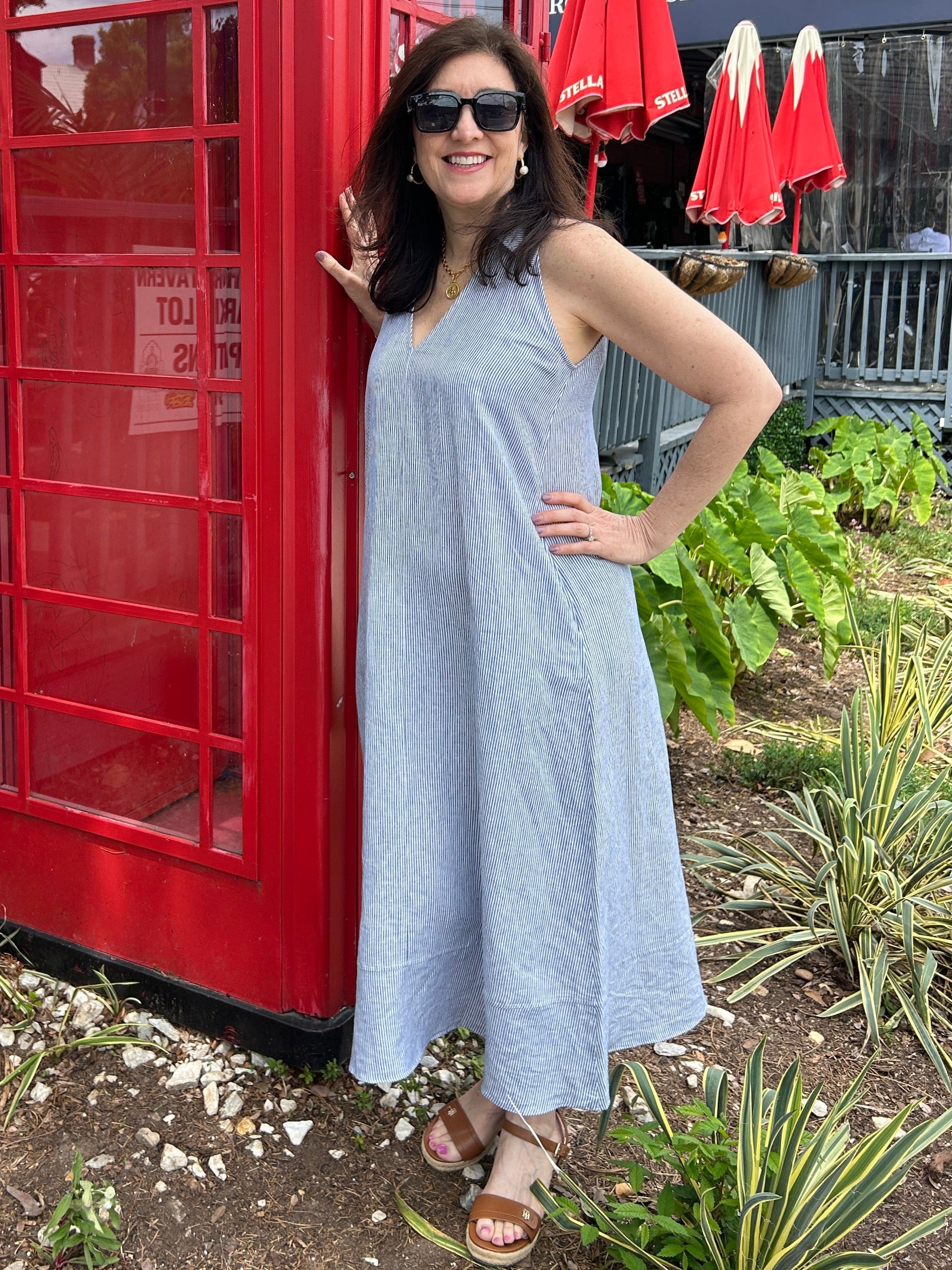 Tara wearing a navy and white pinstripe sleeeless linen maxi dress. It has a fabulous collar and v-neckline. 