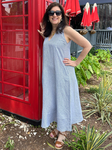 Tara wearing a navy and white pinstripe sleeeless linen maxi dress. It has a fabulous collar and v-neckline. 