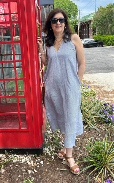 Tara wearing a navy and white pinstripe sleeeless linen maxi dress. It has a fabulous collar and v-neckline. 