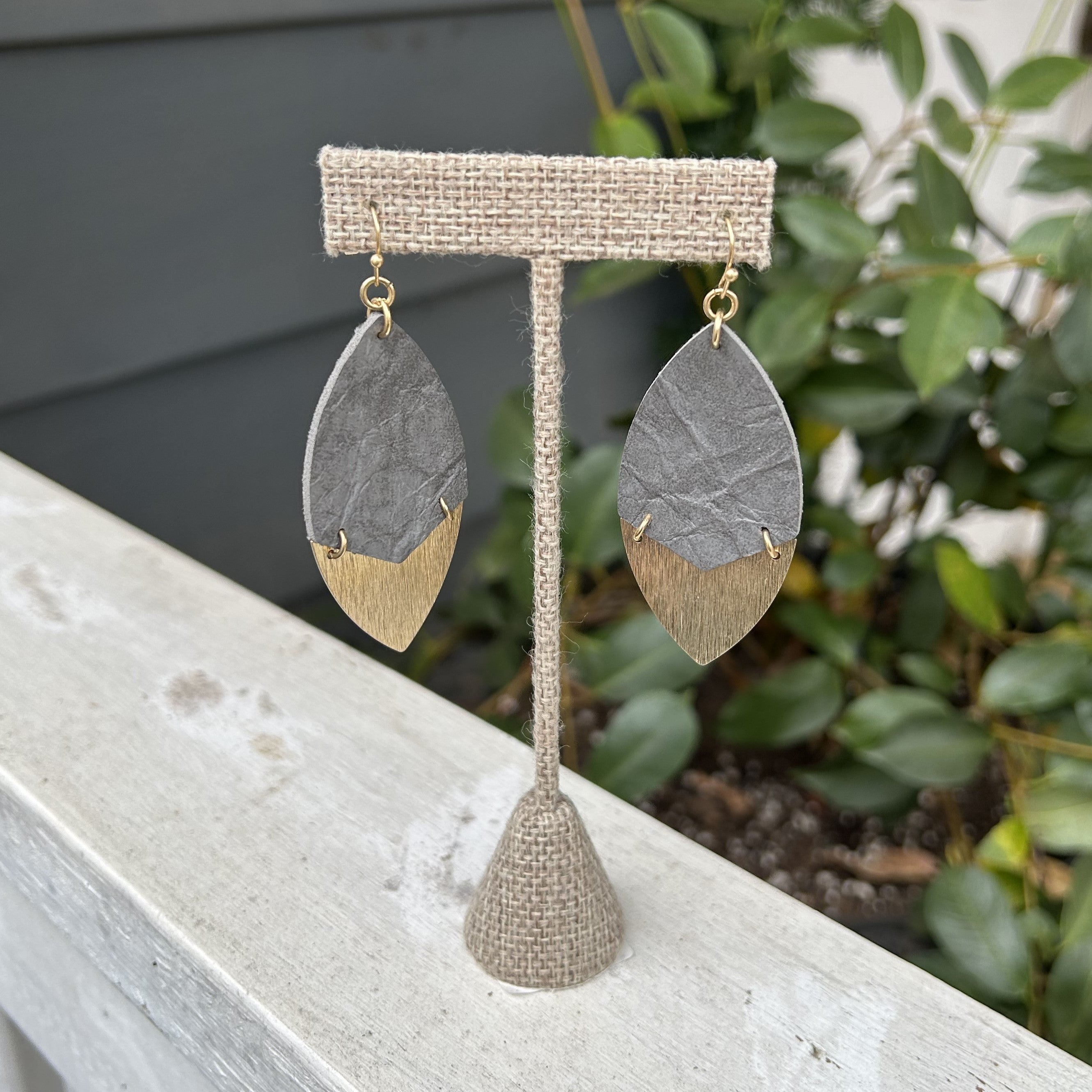 Add a touch of nature to your style with these Leaf Shaped Earrings. The top is a muted gray, while the bottom has a silver sheen, creating a beautiful combination. Add a little uniqueness to your day with these stunning earrings!