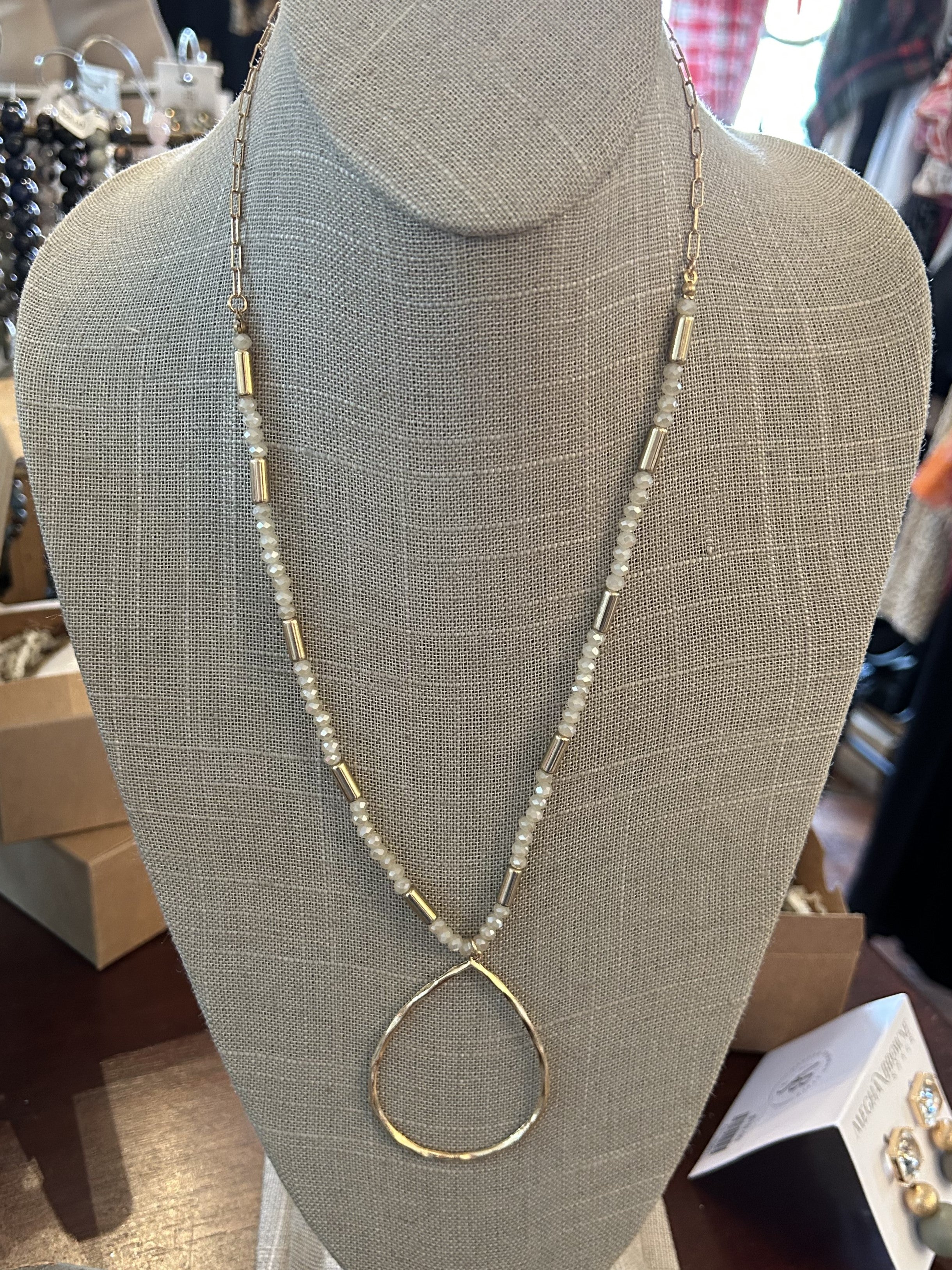 This Long Gold & Crystal Necklace w/ Teardrop Pendant is such a lovely necklace! Its delicate gold and crystal links create a stunning visual, while the teardrop pendant adds a special touch of elegance. The long necklace is an exquisite combination of beauty and style.   Approximate Length: 32-3