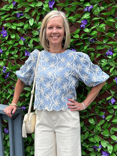 You will love this charming blue and white embroidered top. Delicate embroidery adorns the fabric, while elbow-length sleeves offer a refined silhouette. The scalloped hem adds a feminine touch that pairs beautifully with white jeans, white shorts, or linen pants. A versatile piece that transitions effortlessly from day to evening, this top brings understated elegance to any outfit.

Barbara is wearing a size Small.

Material: 100% Cotton

Care Instructions: Gentle cool hand wash cold, dry flat
