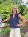 You will love the playful style in this navy linen top. Crafted from breathable linen fabric, it features a flattering V-neckline and charming ruffled cap sleeves that add movement and dimension. The rich navy hue works beautifully for patriotic occasions, game day gatherings, or everyday wear. Perfect for warm weather, this versatile piece transitions seamlessly from casual outings to festive celebrations.

Material: 100% Linen

Care Instructions: Hand wash, hang to dry