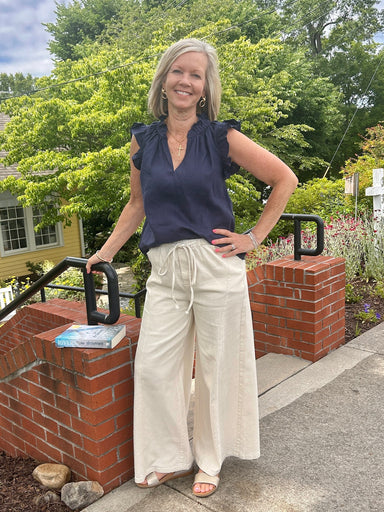 Effortless comfort meets timeless style with these wide-leg pants in soft butter cream. Featuring an adjustable elastic and drawstring waist for a custom fit, front pockets for practicality, and striking vertical stitching details that add visual interest. The relaxed silhouette flatters all body types and pairs seamlessly with everything in your wardrobe—from fitted tops to oversized sweaters. Perfect for casual days when you want to look put-together without sacrificing comfort.

Barbara is wearing a size