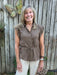 Timeless style meets everyday comfort in this brown button-down top. The adjustable tie waist creates a flattering, customizable fit that works for any body type. Crisp front placket, structured collar, and cap sleeves deliver a polished look that pairs beautifully with everything in your wardrobe. Whether dressed up for the office or down for weekend wear, this neutral essential is the foundation piece every closet needs.

Material: 65% Rayon / 35% Nylon

Care Instructions: Machine wash cold, line dry