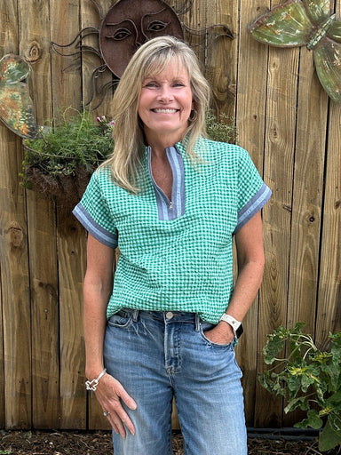This green and blue gingham top by THML wil become a summer go to! It's made of a great, light weight fabric, has such a cute pattern and we love the denim placket and trip on the sleeves.&nbsp;

Carolee is wearing a small with Risen cropped jeans.&nbsp;

Material: 100%&nbsp;

Care Instructions: Gentle cool hand wash cold, dry flat